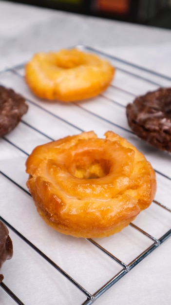 A close up of a donut on a wire rack