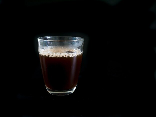 Photo close-up of drink against black background