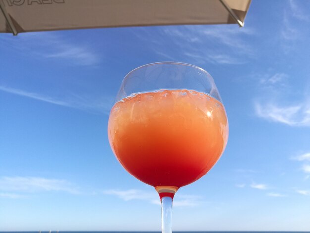 Close-up of drink against blue sky