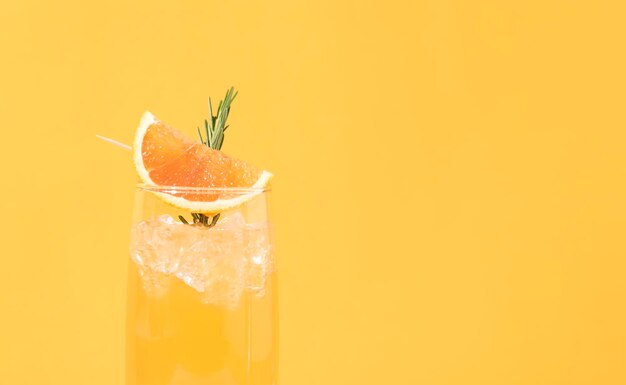 Close-up of drink against orange background