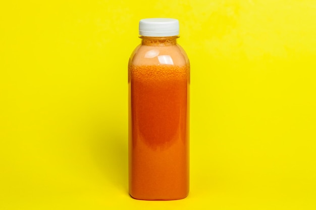 Close-up of drink in bottle against yellow background