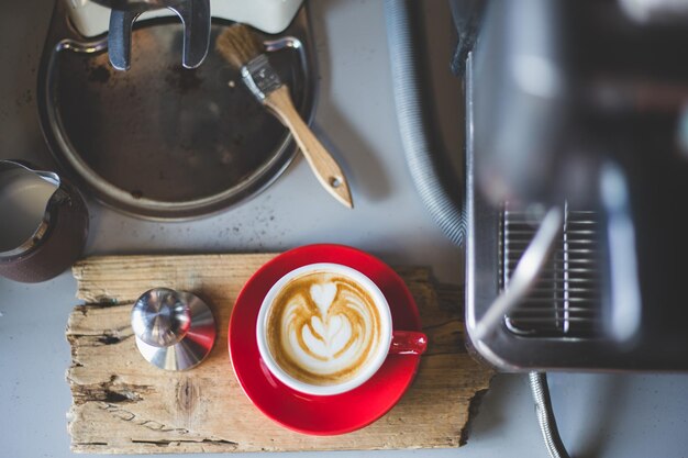 Close-up of drink by coffee maker on table