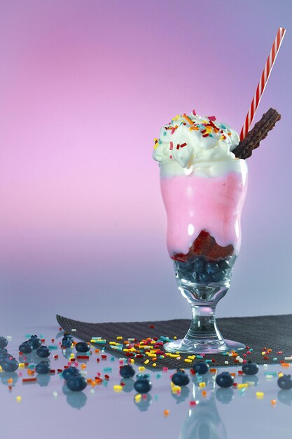 Close-up of drink in glass against pink background