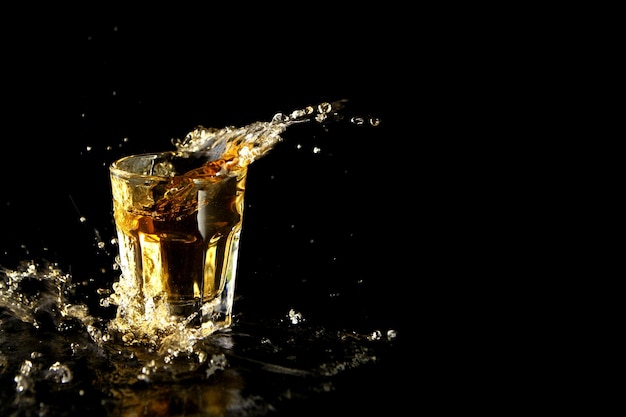 Close-up of drink splashing against black background