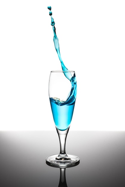 Close-up of drink splashing against white background