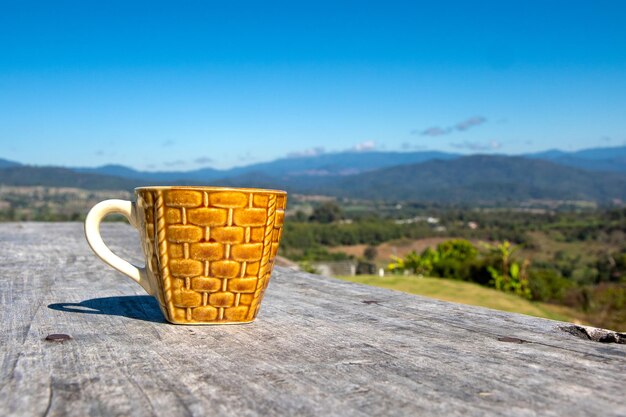 Close-up of drink on table against blue sky