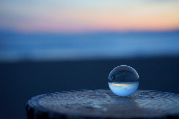 Close-up of drink on table against sea