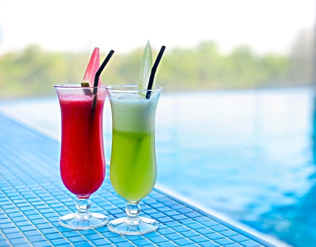 Close-up of drink on table by swimming pool