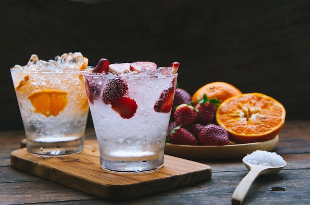 close-up of drinks with fruits on wooden table