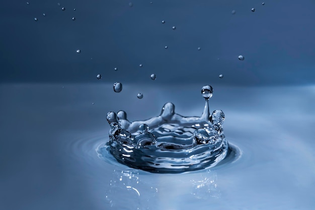 Close-up of drop falling on blue water