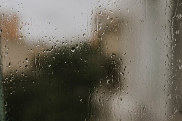 Photo close up on drops of rainwater on the glass