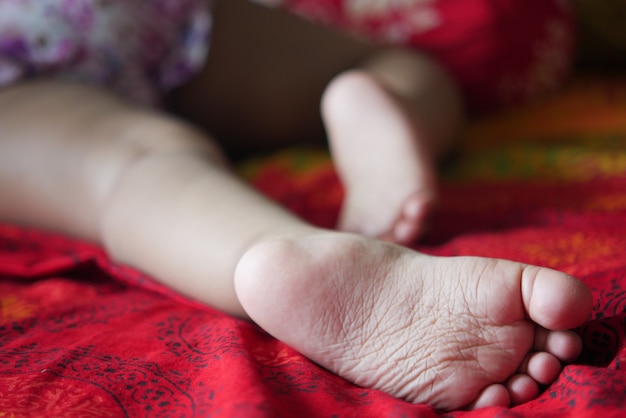 Close up of dry child feet on bed