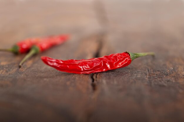 Photo close-up of dry red chili peppers on wood