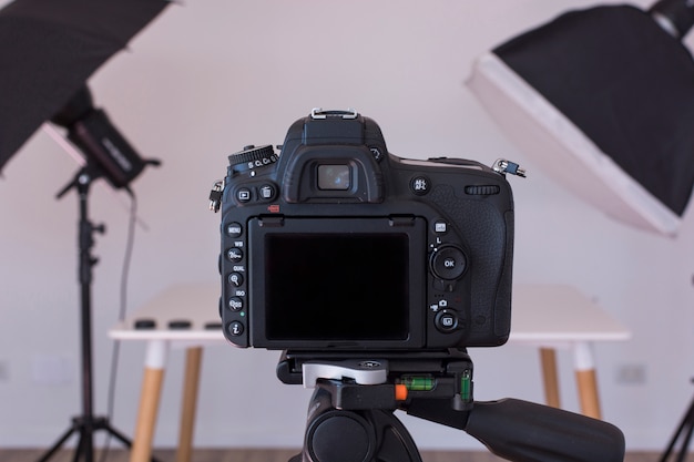 Close-up of dslr camera on a tripod in photo studio