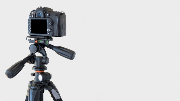 Close-up of a dslr camera on a tripod over white background