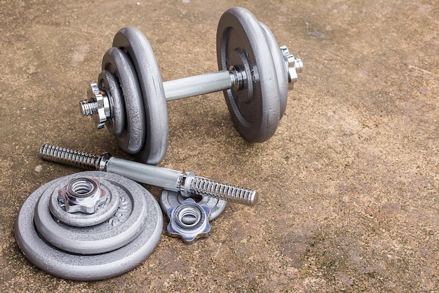 Close up dumbbells on cement floor