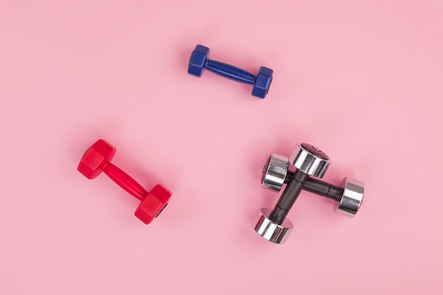 Close-up of dumbbells on pink background
