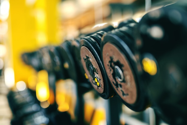 Close up of dumbbells in the row. gym interior