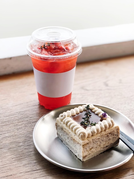 Close-up of earl grey cake with strawberry tea on the table