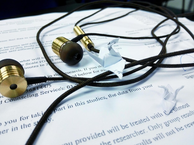 Close-up of earphones on book