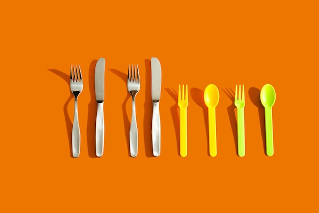 Photo close-up of eating utensils against orange background