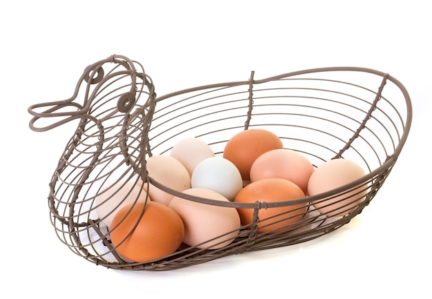 Photo close-up of eggs in basket over white background