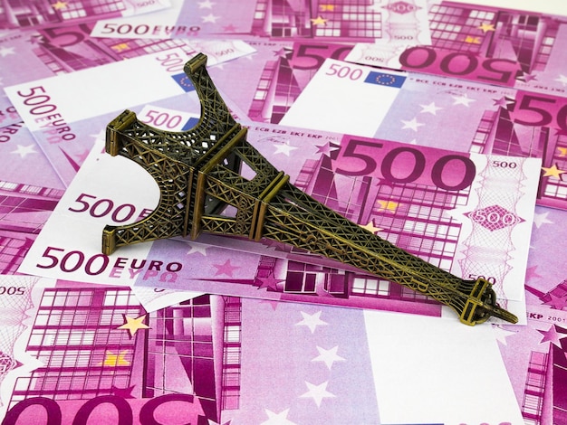 Photo close-up of eiffel tower replica on five hundred euro banknotes at table