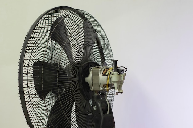 Photo close-up of electric fan against white background