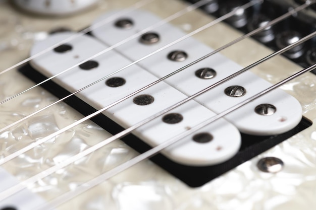 Close-up of electric guitar pickups with strings music background