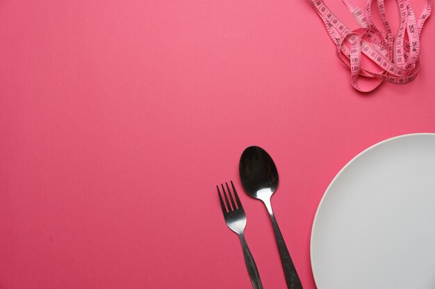 Close-up of electric light on table against pink background