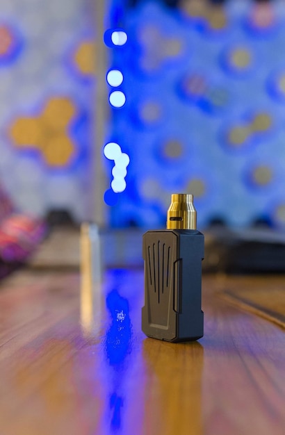 Close-up of electronic cigarette on floor against illuminated light