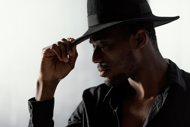 Close-up elegant man with hat posing