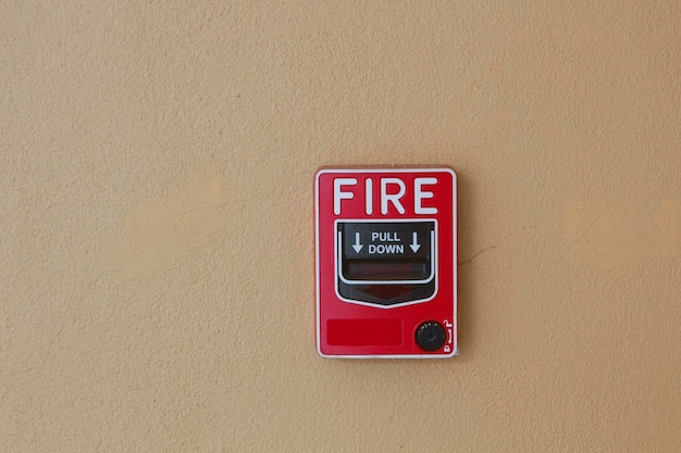 Close-up of emergency equipment with text on wall