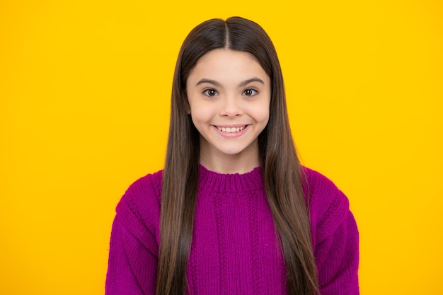 Close up emotional portrait of caucasian smiling teen girl Head shot of cute teenager child on isolated studio background