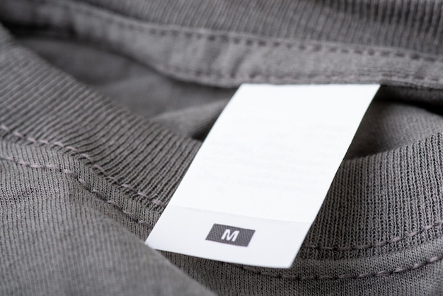 Close up on empty label of a gray tshirt of M size