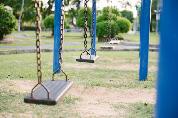 Close-up of empty swings in park