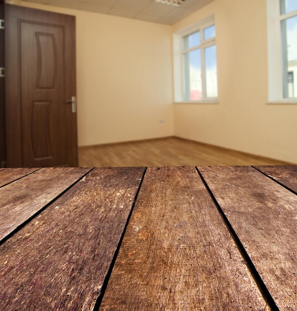 Foto close-up di un tavolo di legno vuoto sul pavimento di casa.