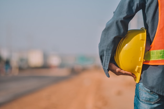 Close up Engineering holding Yellow helmet hard hat safety and Road construction