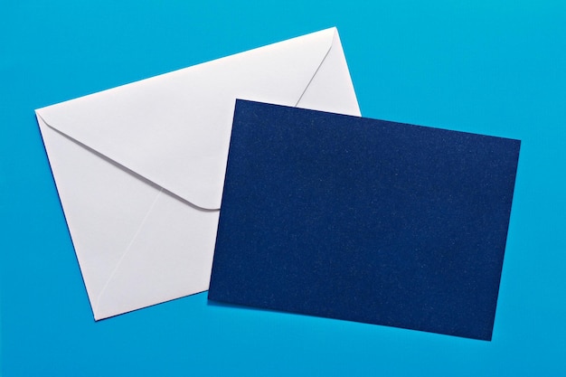 Photo close-up of envelope with blank paper against blue background