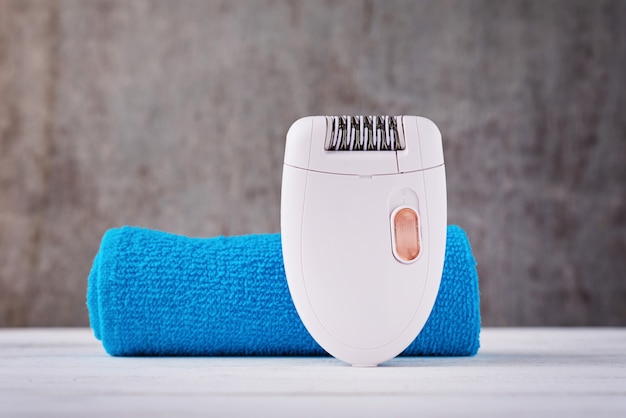 Close up of epilator on background with towel