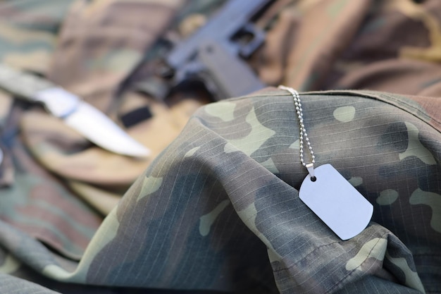 Close-up of equipment over camouflage clothing