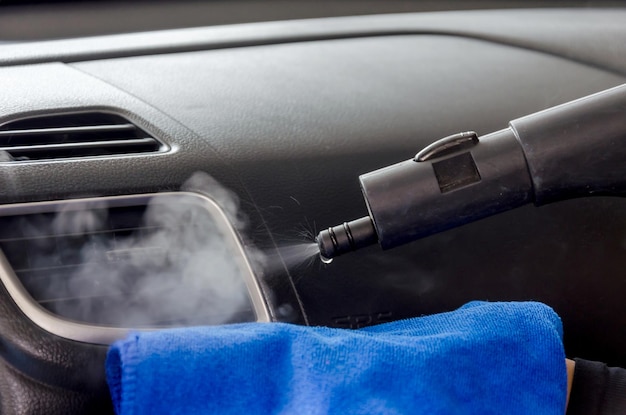 Close-up of equipment spraying water on air condition in car