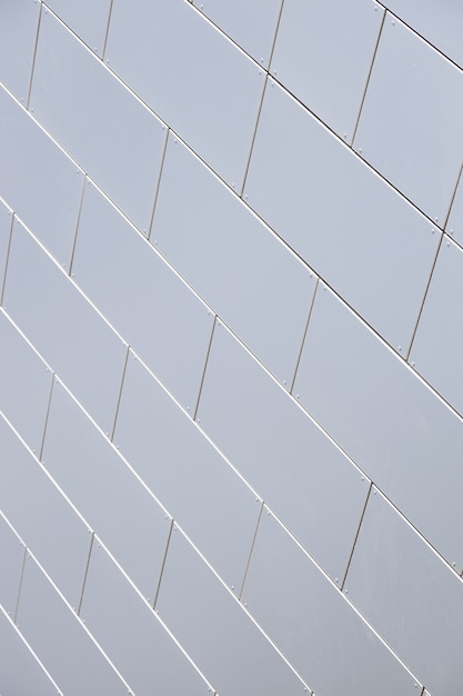 Close-up of even white tiled wall of building