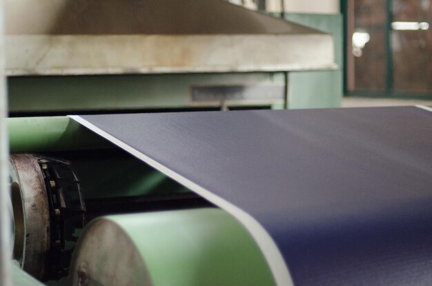 Photo close-up of exercise mat on conveyor belt in factory