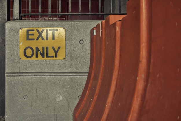 Photo close-up of exit only sign on wall