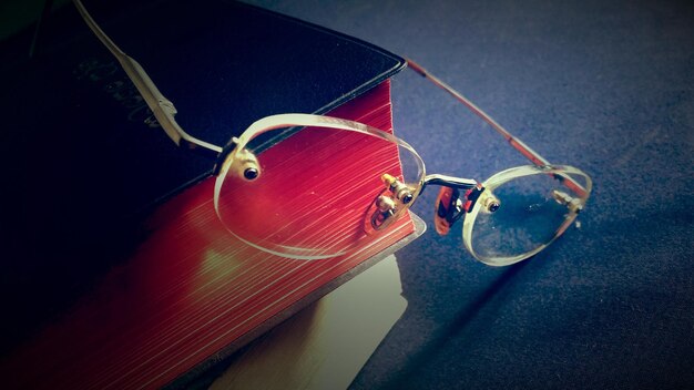 Photo close-up of eyeglasses on book at table