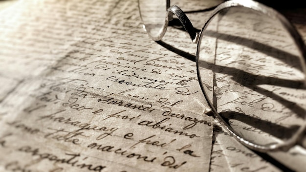 Close-up of eyeglasses on letter