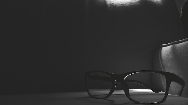 Photo close-up of eyeglasses on table in darkroom