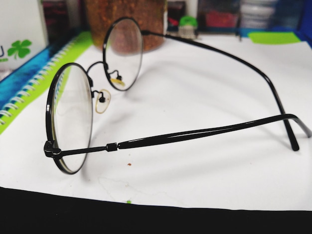 Photo close-up of eyeglasses on table