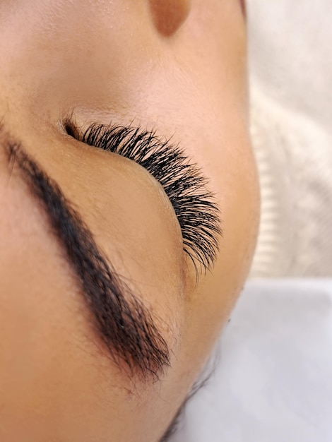 Photo close up of eyelash extensions in beauty salon